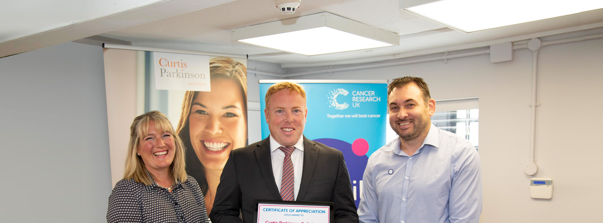 HONOURED FOR HELPING TO SECURE VITAL FUNDS FOR CANCER RESEARCH UK